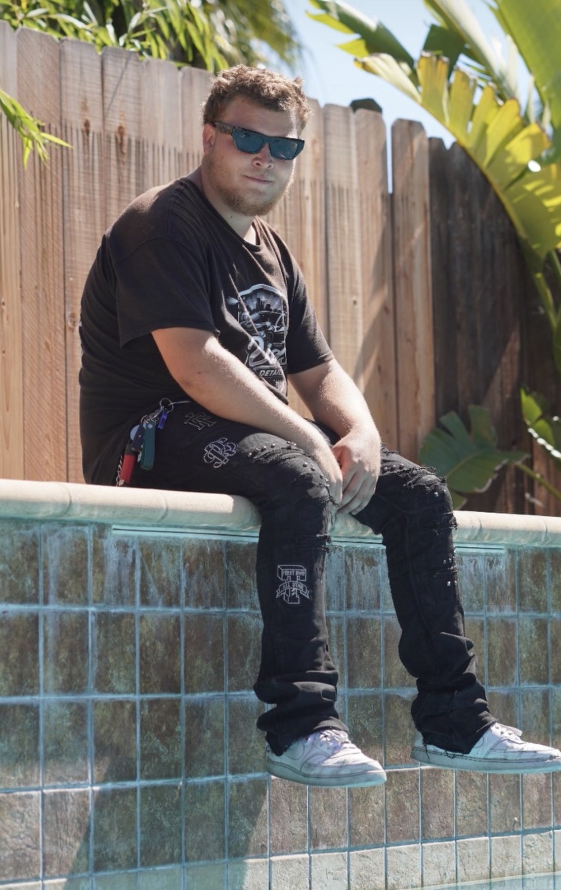 David sitting outside wearing David's Detailing shirt
